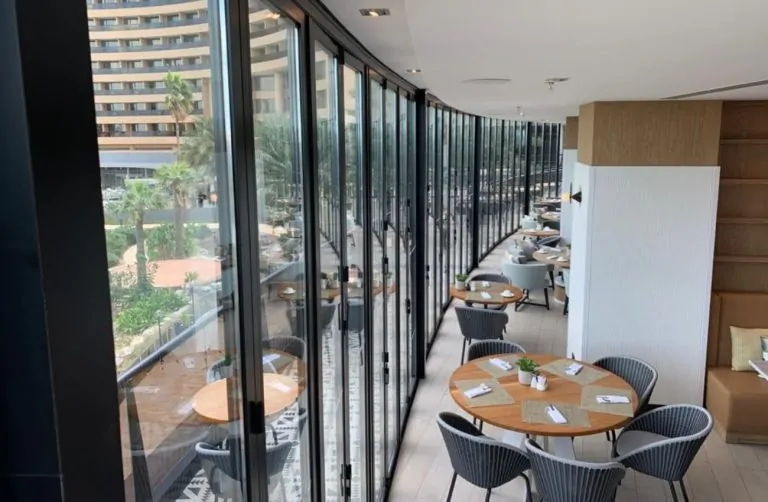 Aluminium bifold doors in modern restaurant terrace with glass enclosure